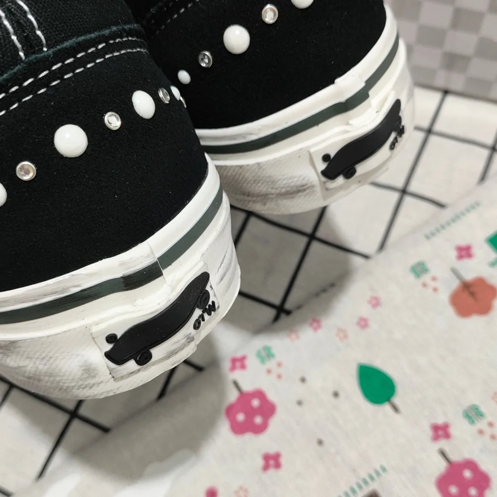 Vans Black Canvas Slip-On Sneakers with Maroon Lining and White Stud Detail